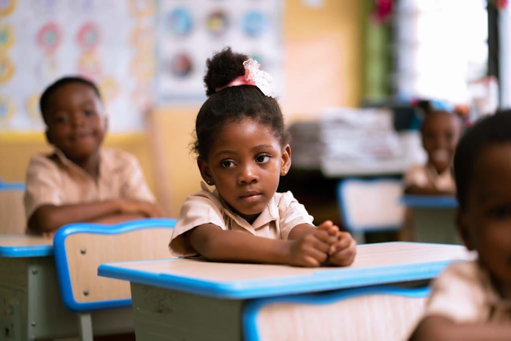 Young student attentively learning at classroom desk